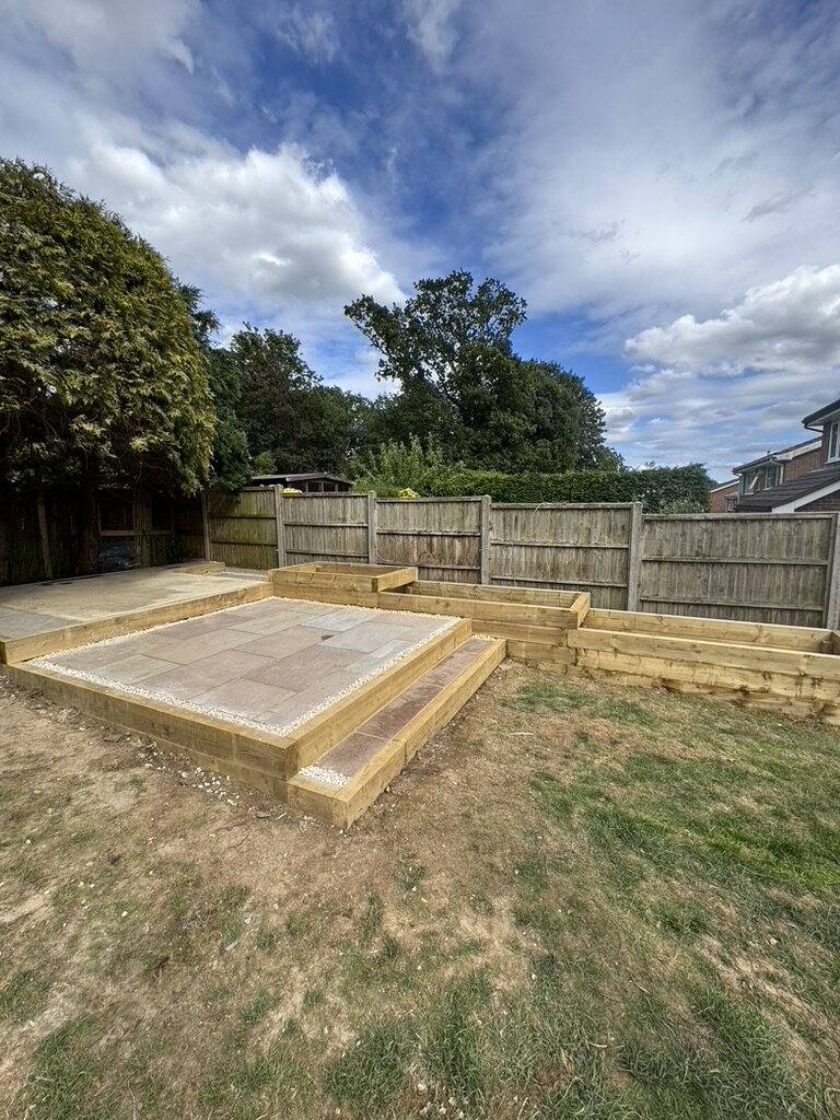 Timber sleeper-edged base set out on a lawn ready for paving